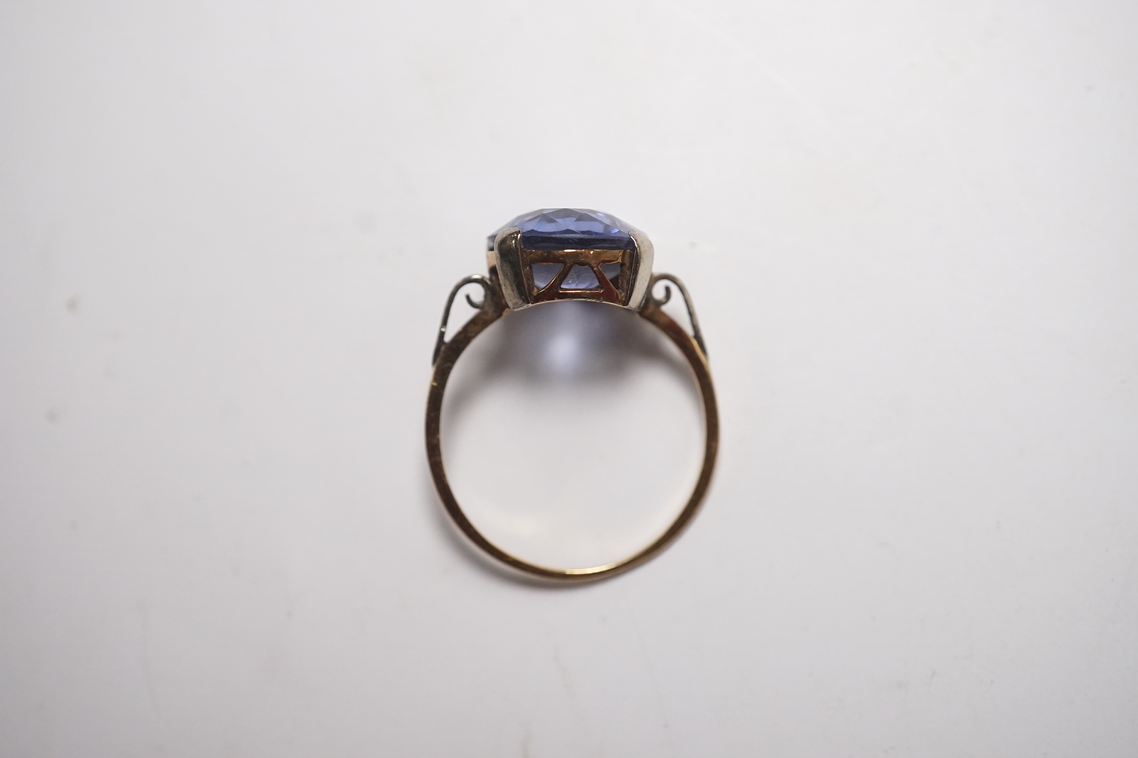 A yellow metal and single stone oval cut synthetic? sapphire set ring, size N, gross weight 2.8 grams. Condition - poor to fair